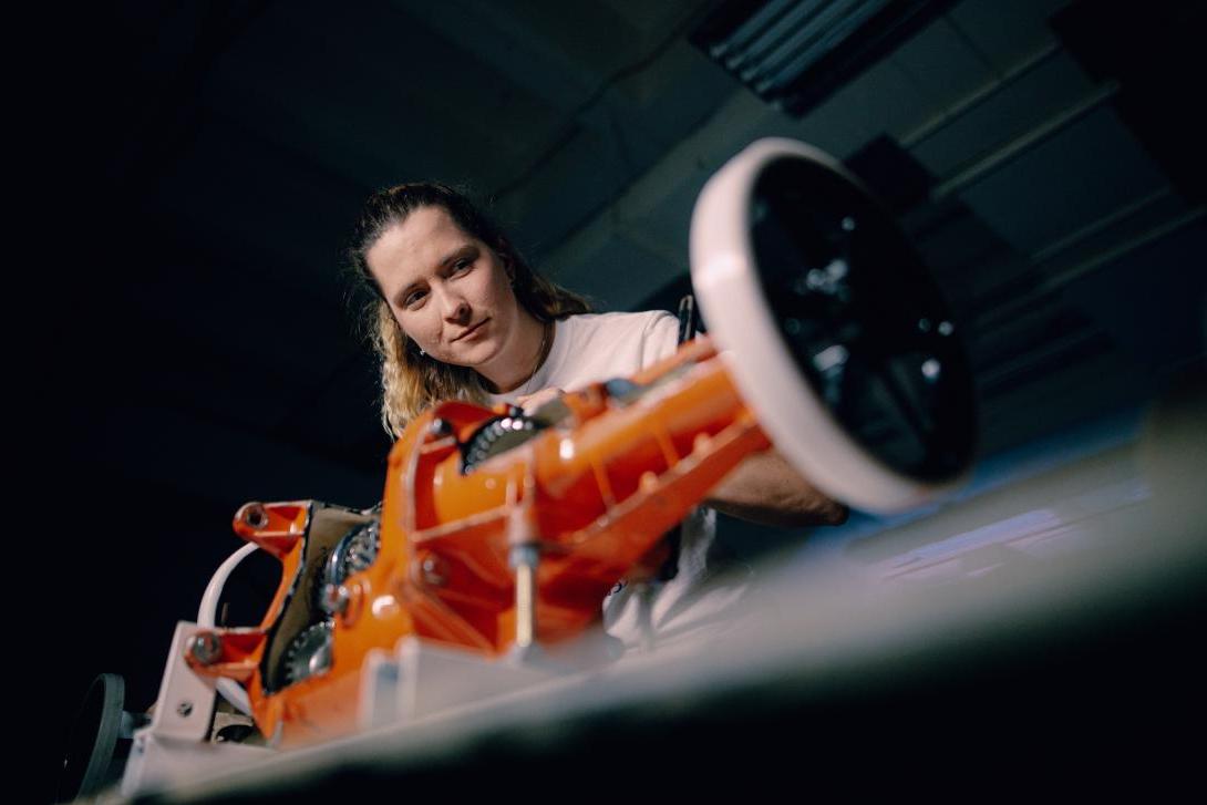 young lady examining motor 